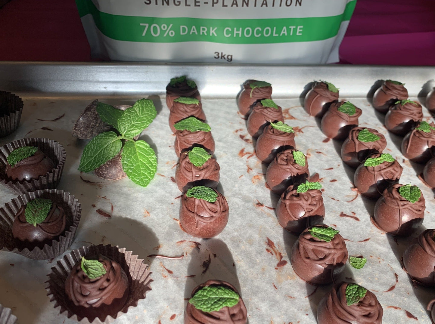 rows of 70% dark chocolate mint truffles topped with mint leaf