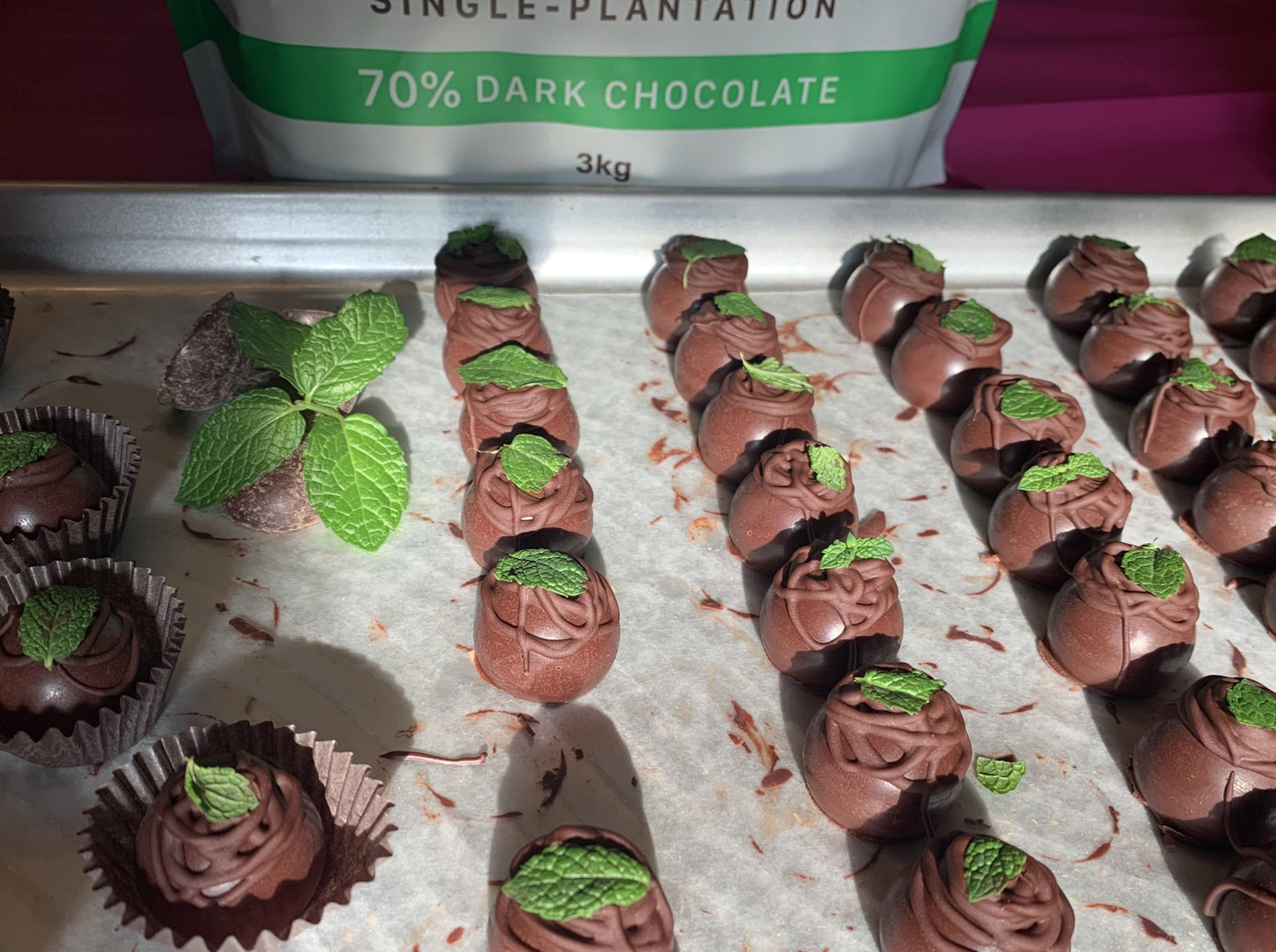 rows of 70% dark chocolate mint truffles topped with mint leaf